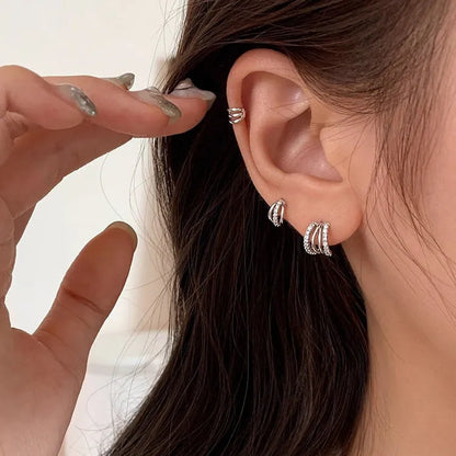 A pair of geometric-shaped 925 sterling silver earrings with a polished finish on a white background.