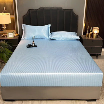 Houndstooth ice silk jacquard fitted three-piece bedding set in ice blue, 180x200cm size with pillowcases on white bed