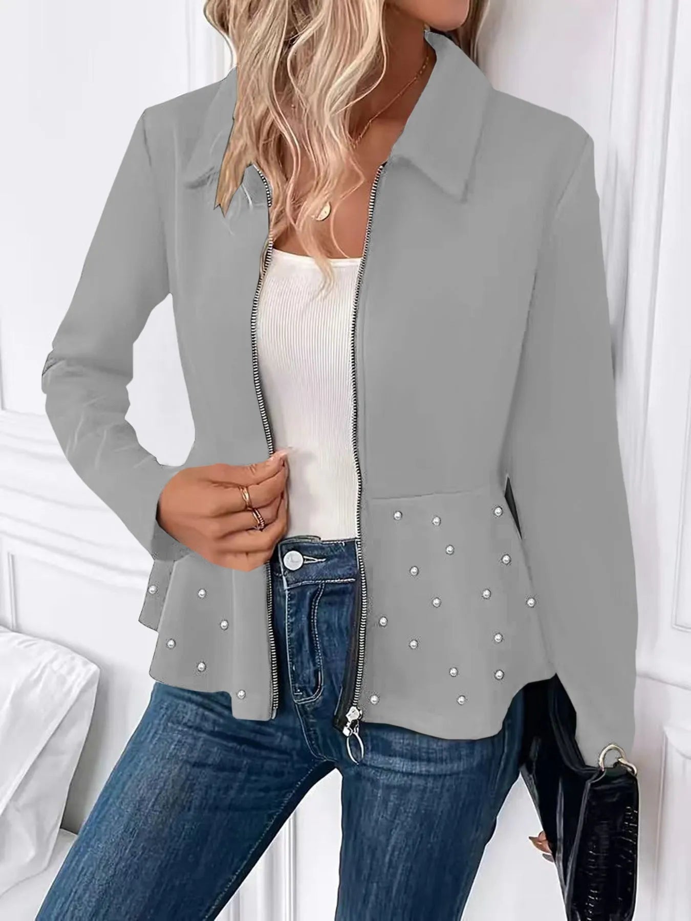 Women's black coat with heavy-duty zipper and ruffled hem detail in loose-fitting silhouette