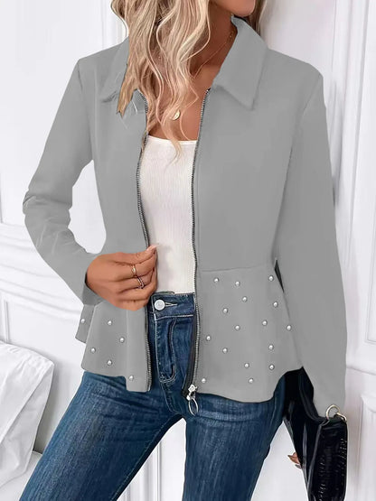 Women's black coat with heavy-duty zipper and ruffled hem detail in loose-fitting silhouette