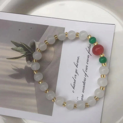 Chinese style glass bead bracelet with bamboo joint design on wrist.