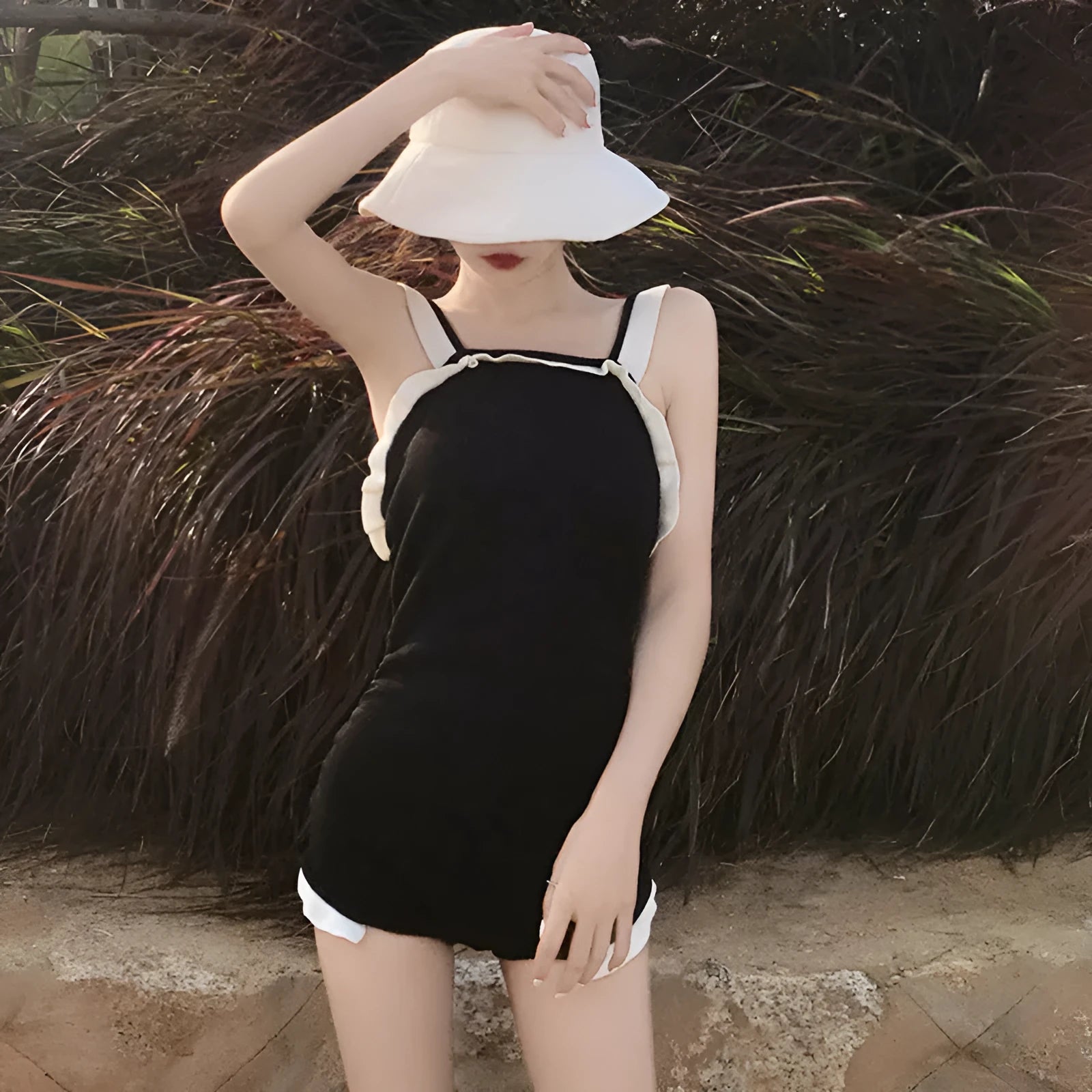 Women's conservative one-piece swimsuit in nylon fabric showing colour options including black with white edge trim