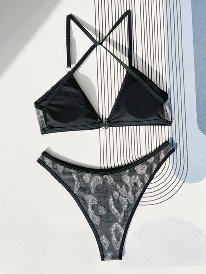 Women's black polyester bikini swimsuit with adjustable straps laid flat