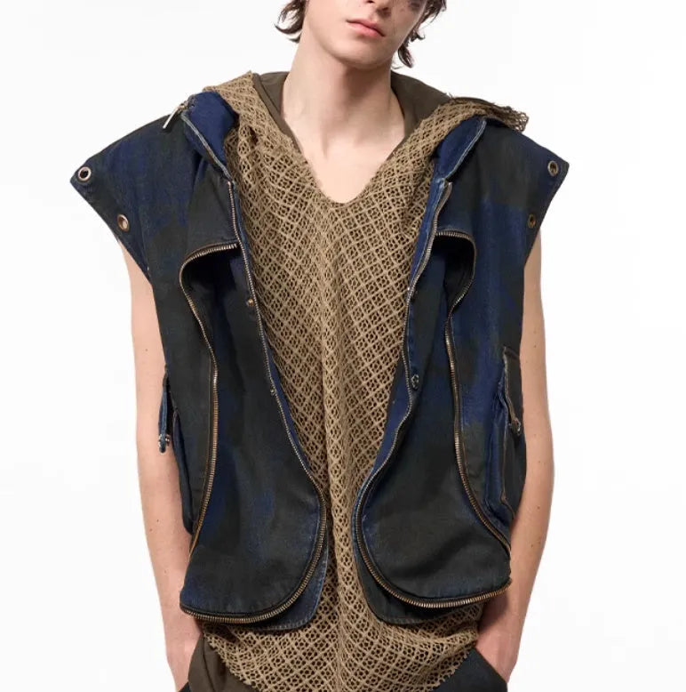 Blue hooded denim vest coat with front zip worn with matching trousers in a two-piece set.