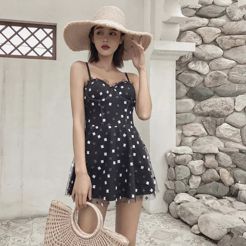 One-piece swimwear in white and black, made from 100% polypropylene for water resistance