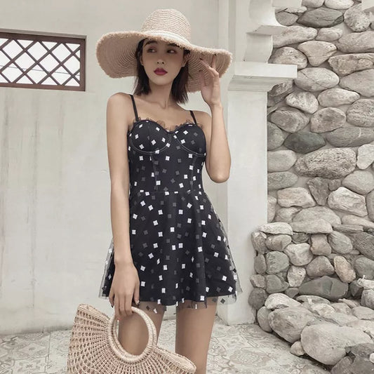 One-piece swimwear in white and black, made from 100% polypropylene for water resistance