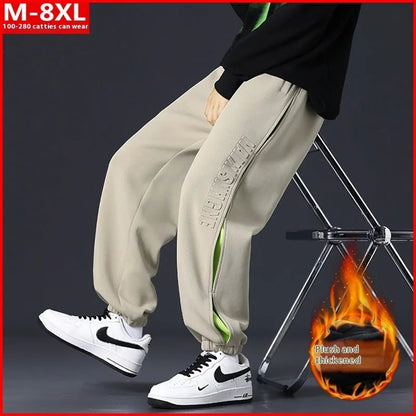 Men's ankle banded trousers in micro-elastic cotton with collage stitching details, showing loose fit and tapered leg