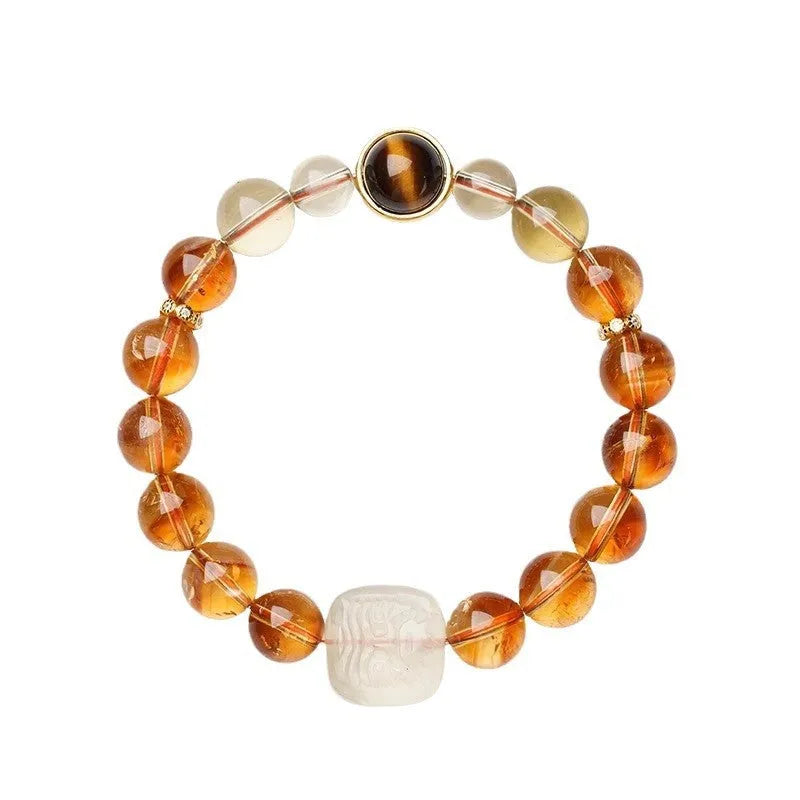 Close-up of a women's carved citrine bracelet with geometric patterns on 10mm crystal beads.