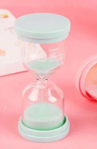 Glass sand timer with coloured quicksand in blue, green, pink, or purple options for 5-30 minute timing