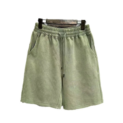 Men's distressed light blue cotton shorts with a loose straight-leg casual fit on a neutral background