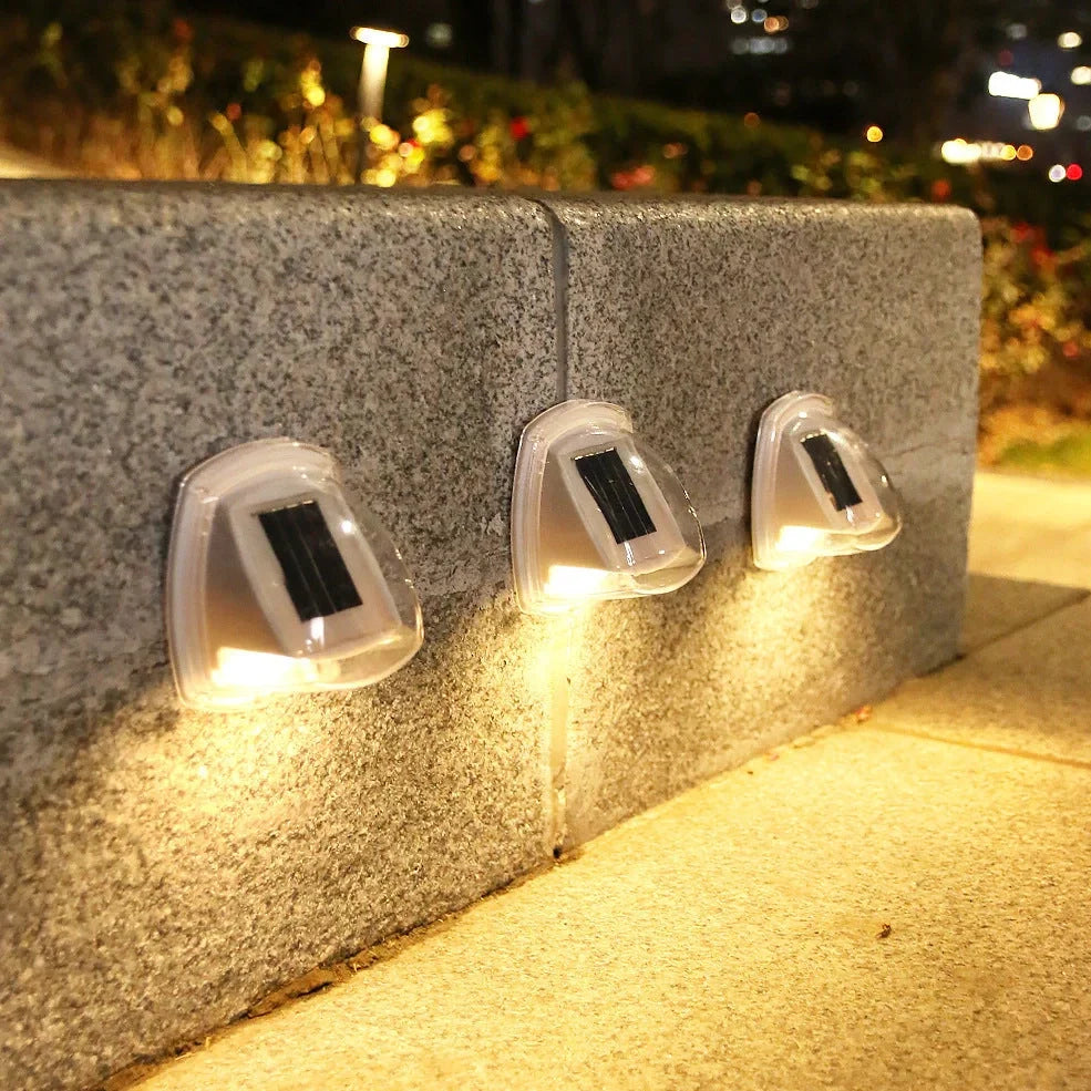 Solar garden wall lamp with waterproof housing mounted on brick wall