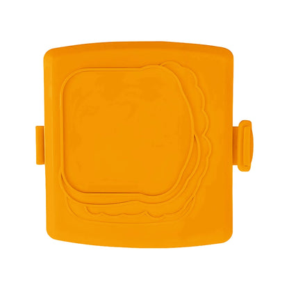 Red silicone baking tray with handbag-shaped mould and matching heat-resistant gloves on kitchen counter