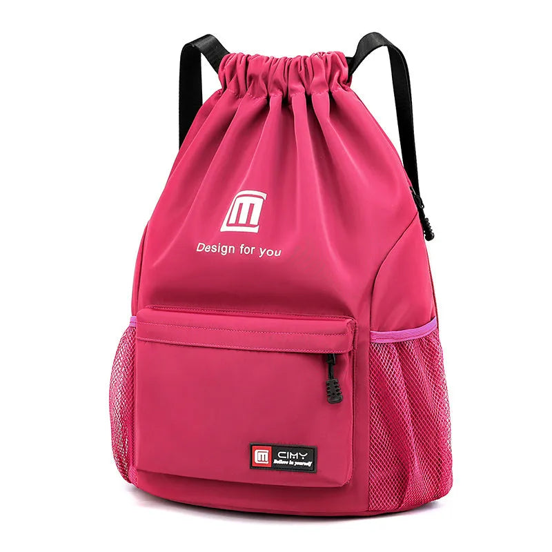 Large bucket-shaped travel backpack in blue with drawstring closure and soft black shoulder straps.