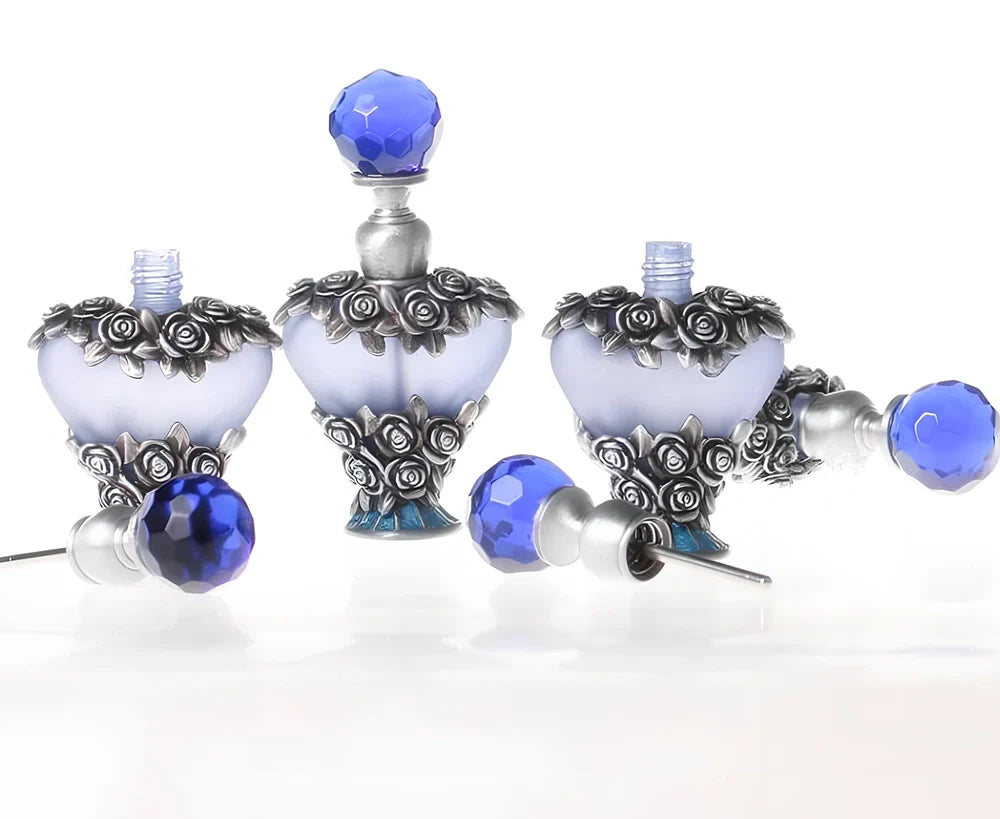 Heart-shaped refillable perfume bottle with metal and crystal construction, 3.6 inches tall