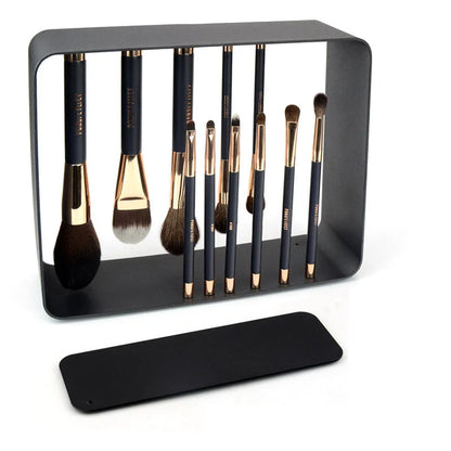 A premium makeup brush set with a sleek black and gold design, featuring 11 essential brushes and a magnetic holder for easy organization.