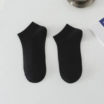 Pair of solid colour low-cut polyester boat socks for men, shown in one of six available colour options.
