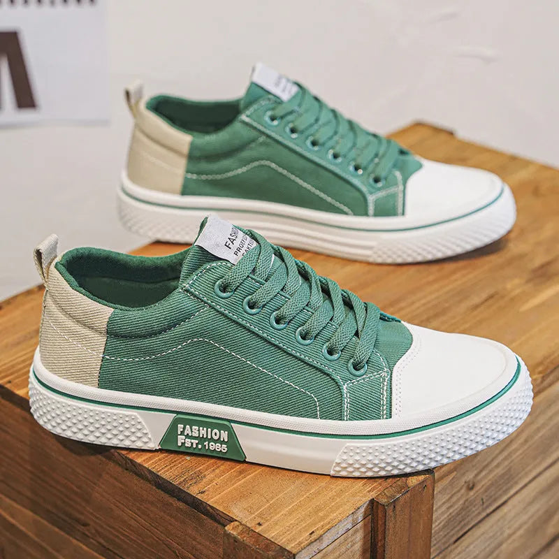 Men's low-top blue canvas skate shoes with round toe and flat heel on a white background.