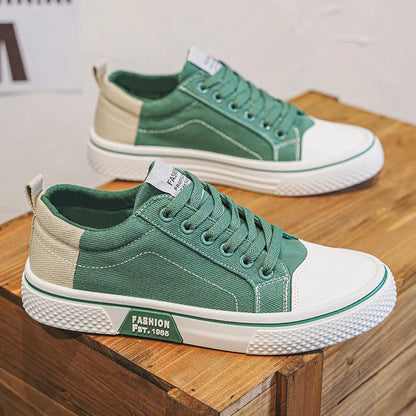 Men's low-top blue canvas skate shoes with round toe and flat heel on a white background.
