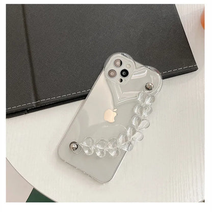 Transparent TPU iPhone case with love bracelet and heart chain design on a table.
