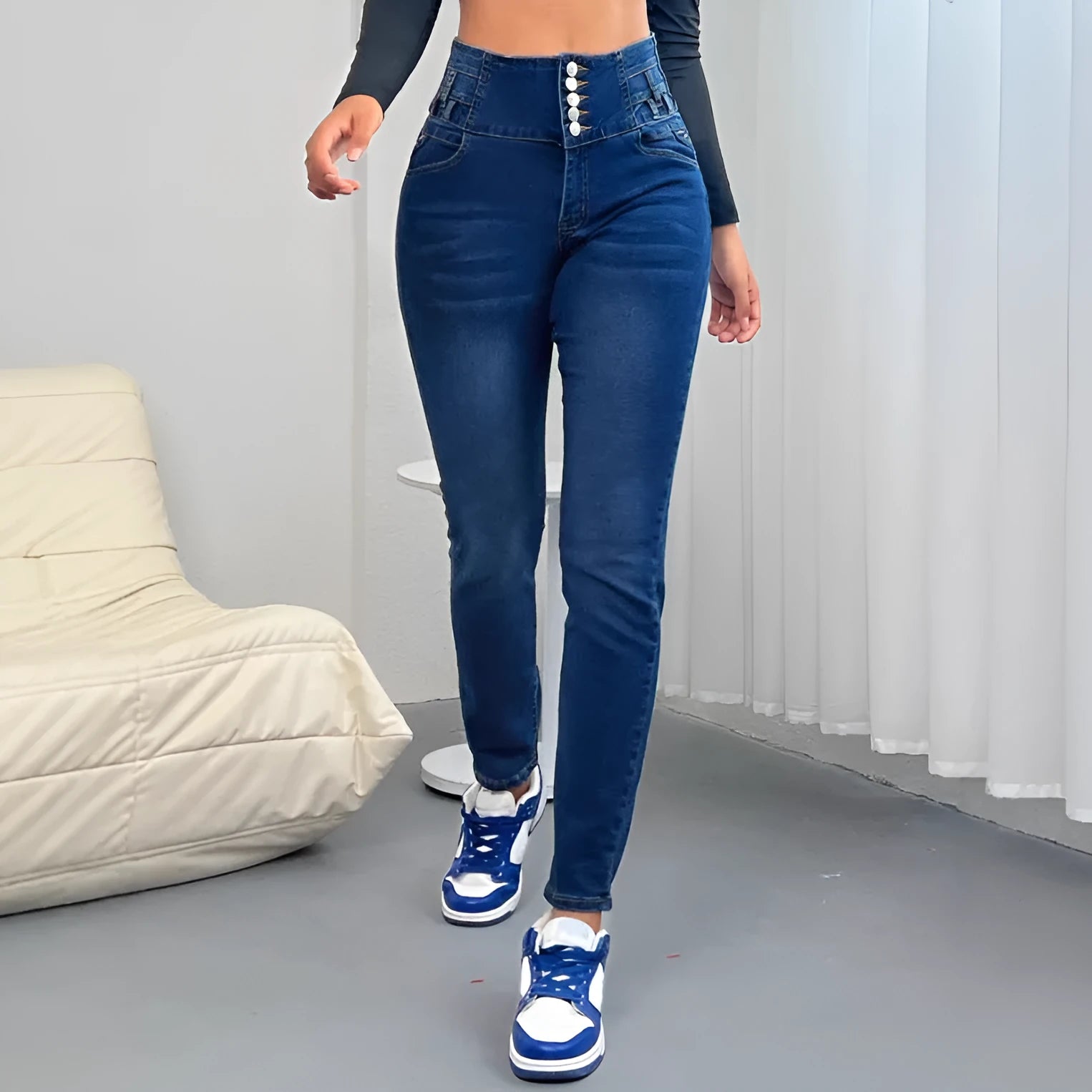 Women's dark blue straight-leg denim trousers with button details and a zipper fastening.