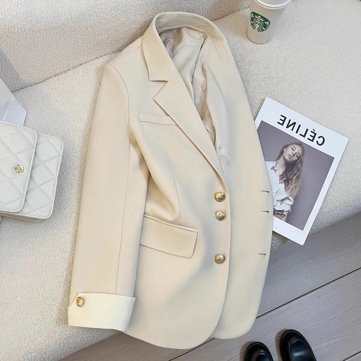 Milky white loose fit Korean-style women's coat with long sleeves and pockets.