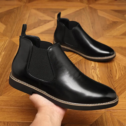 Black and brown formal pointed-toe leather boots with a square heel on a rubber sole.