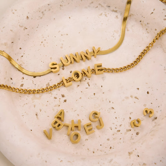 INS Commuter's necklace with 40.5cm titanium steel chain and electroplated gold or silver charms for personalisation