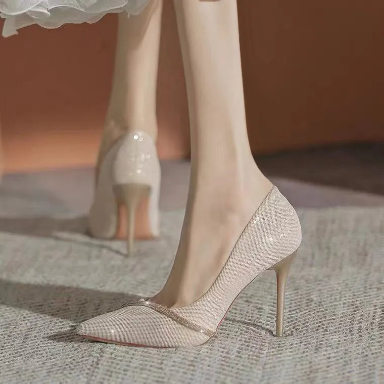 Women's black and gold pointed toe stiletto high heels with low-cut vamp