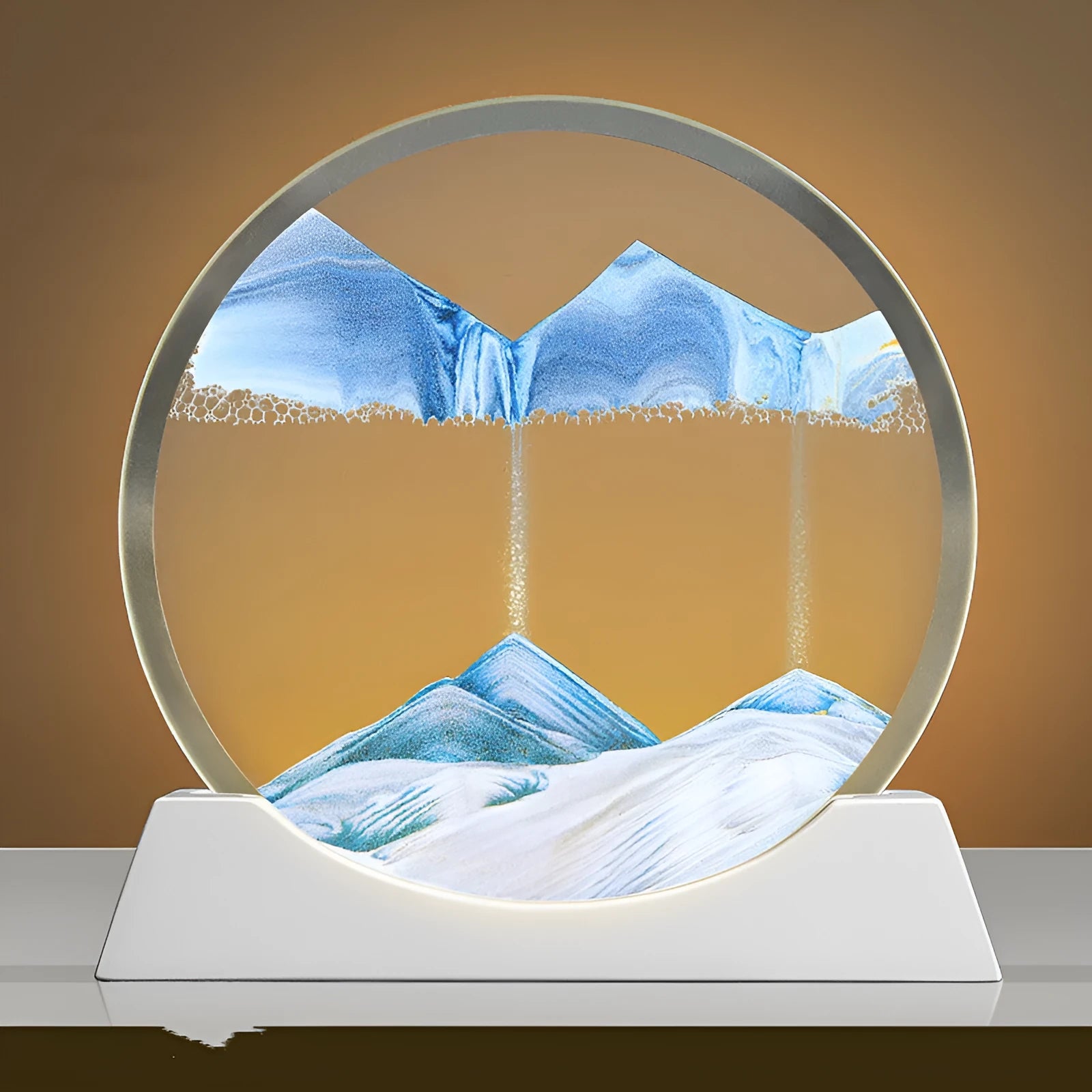 A rotary abstract night lamp with coloured sand falling inside clear glass, showing blue variant.