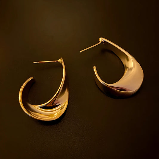 Gold twisted geometric metal earrings with circular elements and electroplated finish