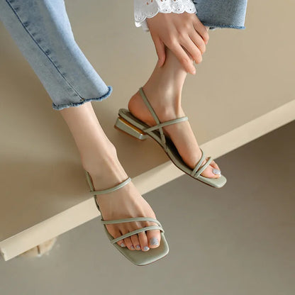 Women's flat strap Roman sandals with square toe in microfiber, showing adjustable ankle strap and multiple colour options