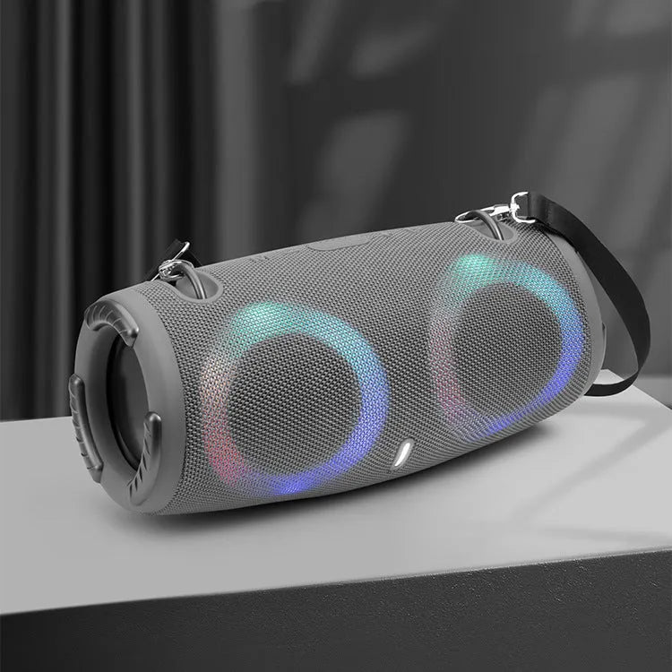 War Drum Bluetooth speaker in blue with RGB coloured lights, showing waterproof design and included strap for portable use