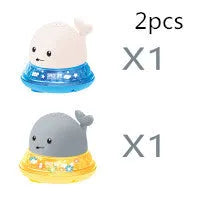 Automatic water-spraying whale bath toy with colourful lights floating in bath water.