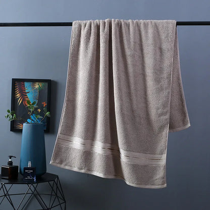Three-piece cotton towel set showing bath towel, towel, and square scarf in coordinating colours