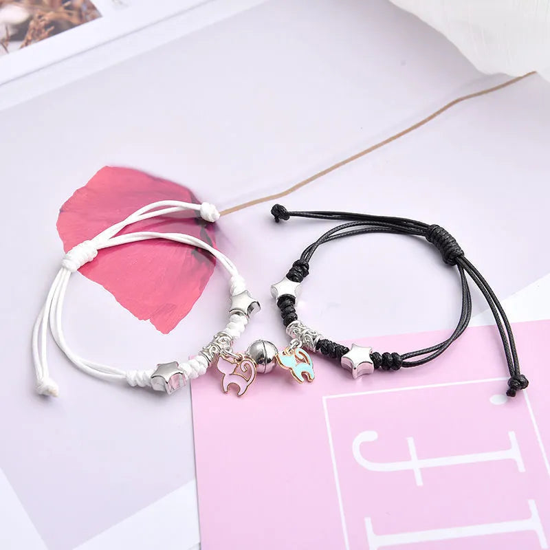 Magnetic suction couple bracelet pair in alloy with an electroplated finish, showing example designs like a crown and love lock.