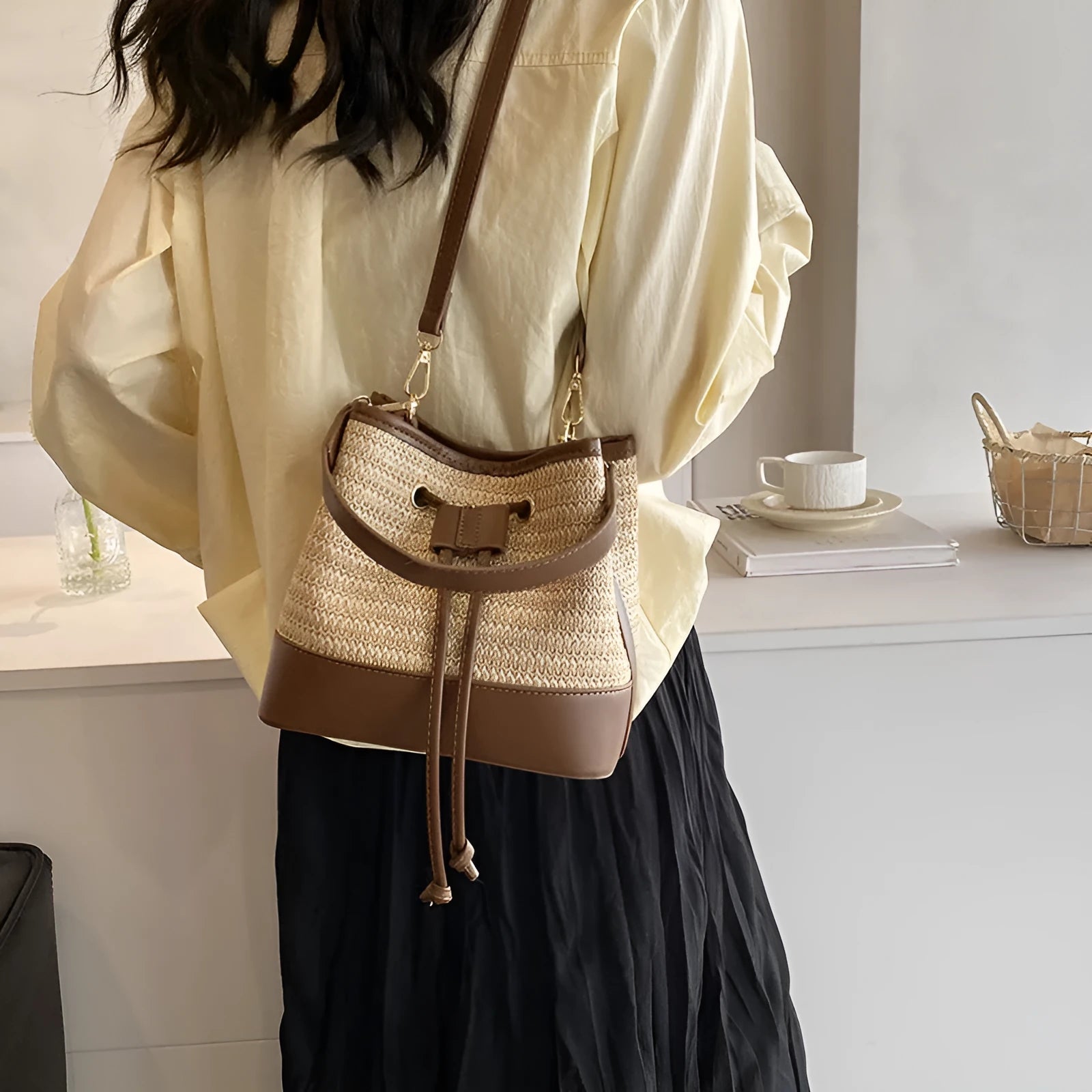 Woven straw women's crossbody bucket bag in brown colour with adjustable strap
