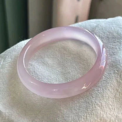 Natural agate wide tyre bracelet showing the stone's colour and the band's solid design on a wrist.