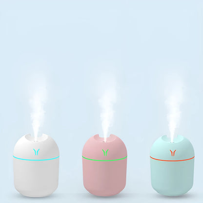 Mini round aromatherapy diffuser in ivory white with USB cable and essential oil bottle