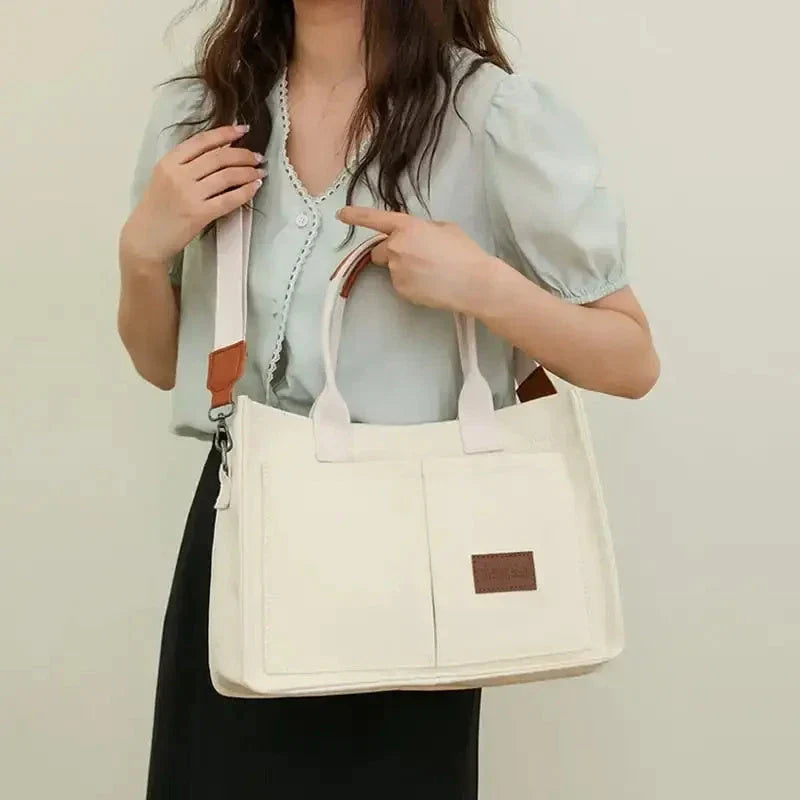 Premium canvas tote bag in multiple colors with adjustable shoulder strap and organizational pockets
