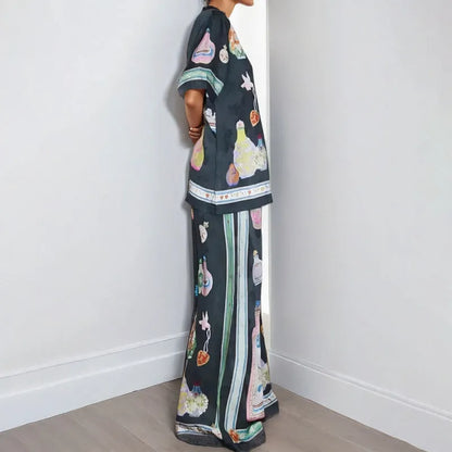 Black women's cardigan set with cartoon animation print, showing top with regular sleeves and matching trousers