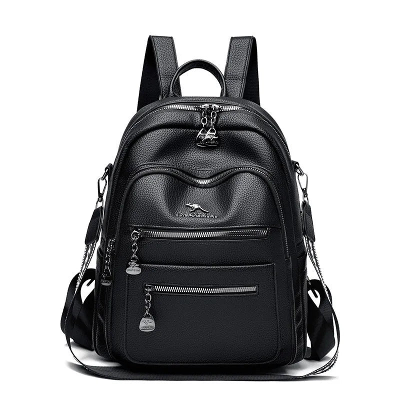 Genuine leather multi-functional commuting backpack with flap pocket, polyester lining, and metal letter patchwork details in black.