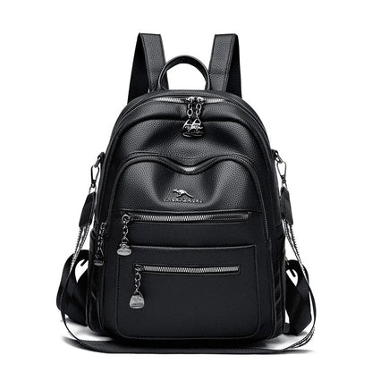Genuine leather multi-functional commuting backpack with flap pocket, polyester lining, and metal letter patchwork details in black.