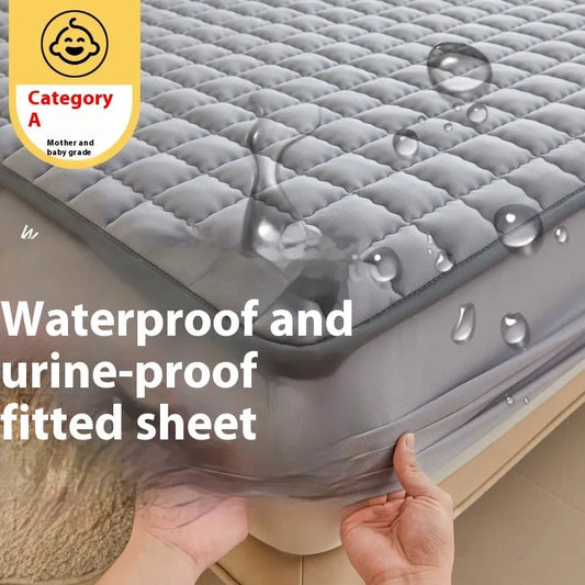 Class A waterproof fitted sheet in light grey colour, showing edging and quilting details on a bed