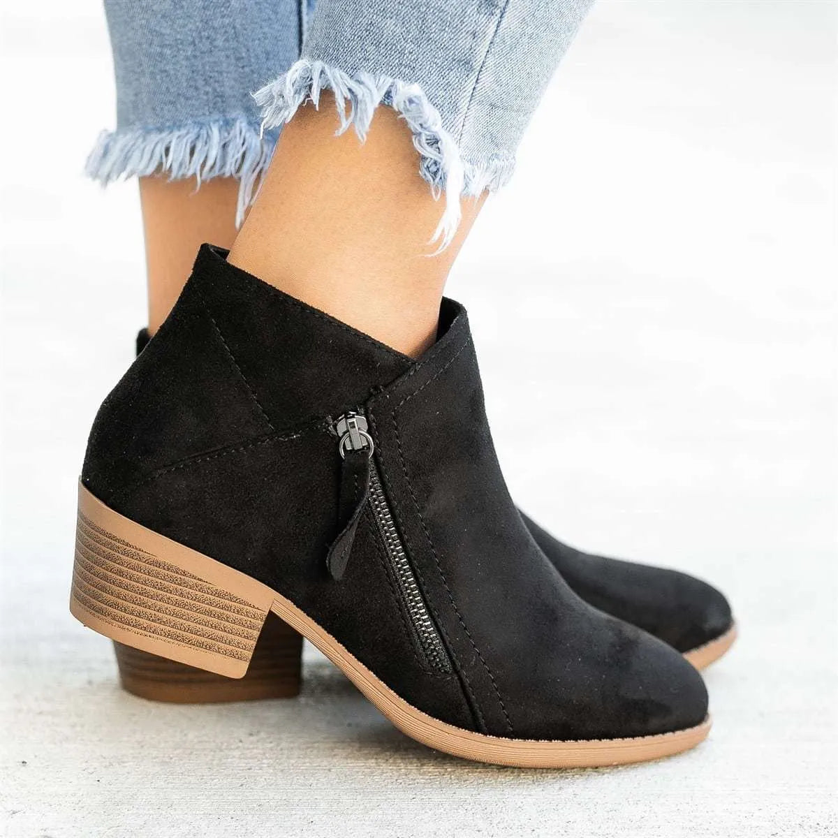 Women's blue suede Dr Martens ankle boots with side zip and chunky heel.