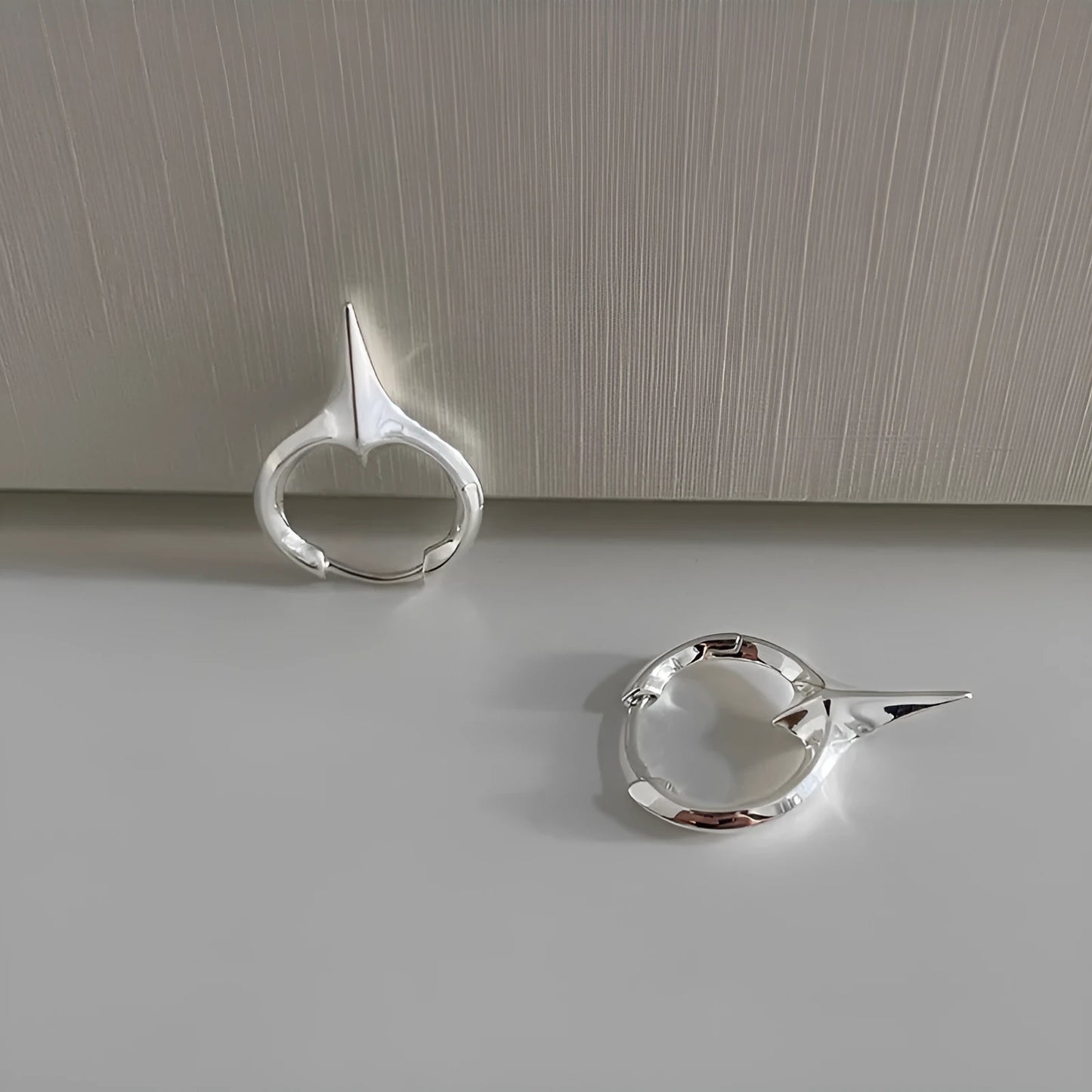 Geometric star-shaped ear clip for women in a platinum electroplated finish.