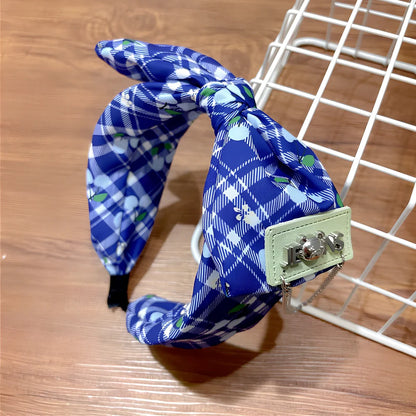 Geometric fringed headband in cloth material with manual craftsmanship details