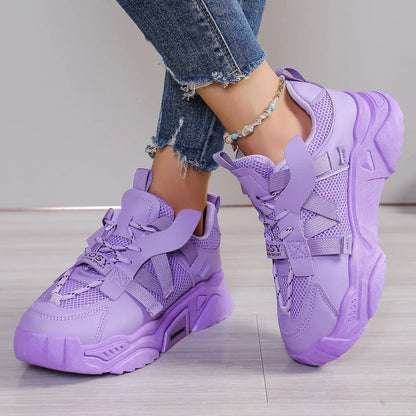 Women's platform sneakers in animal print with breathable mesh upper and front lace-up design.