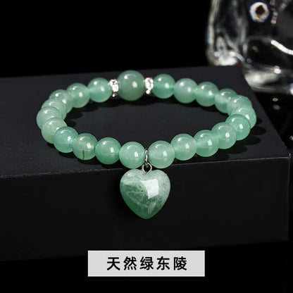 Handmade women's bracelet with natural gemstone beads and a silver love pendant charm.