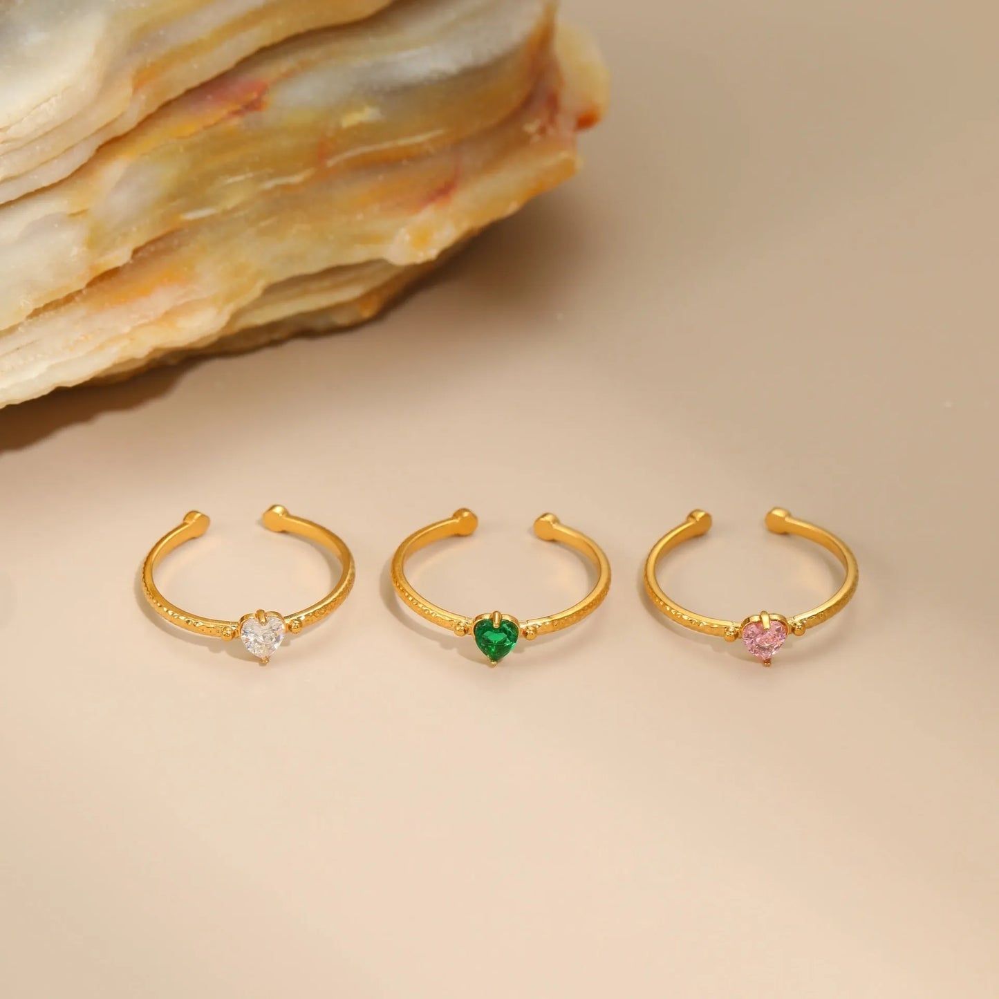 Open-ended stainless steel ring with geometric love heart shape and inlaid green zircon stone.