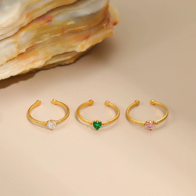 Open-ended stainless steel love heart ring with inlaid zircon, free size geometric shape for stacking and layering in white, pink, or green zirconium heart colour.